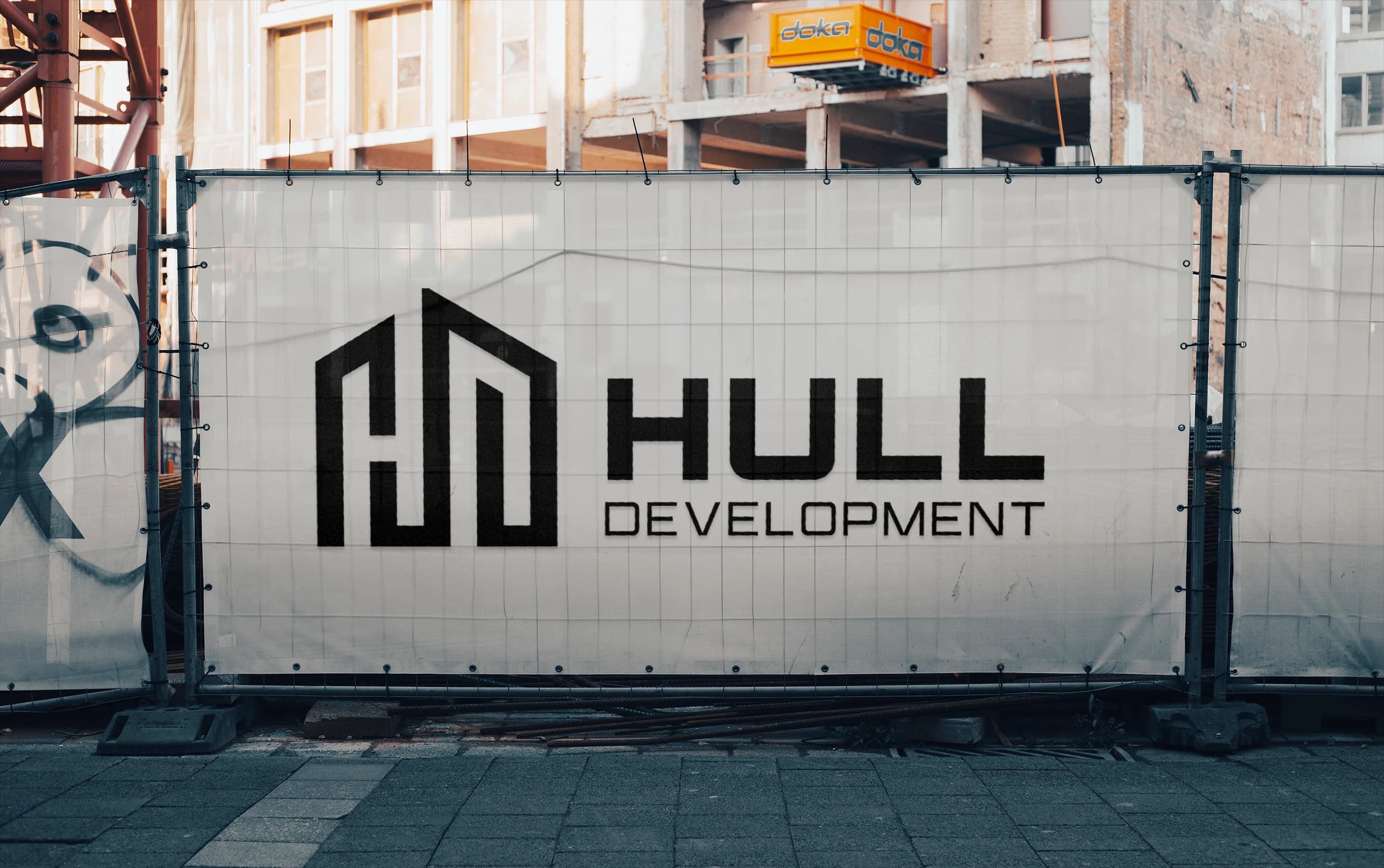 Fence grid with Hull Development logo on it