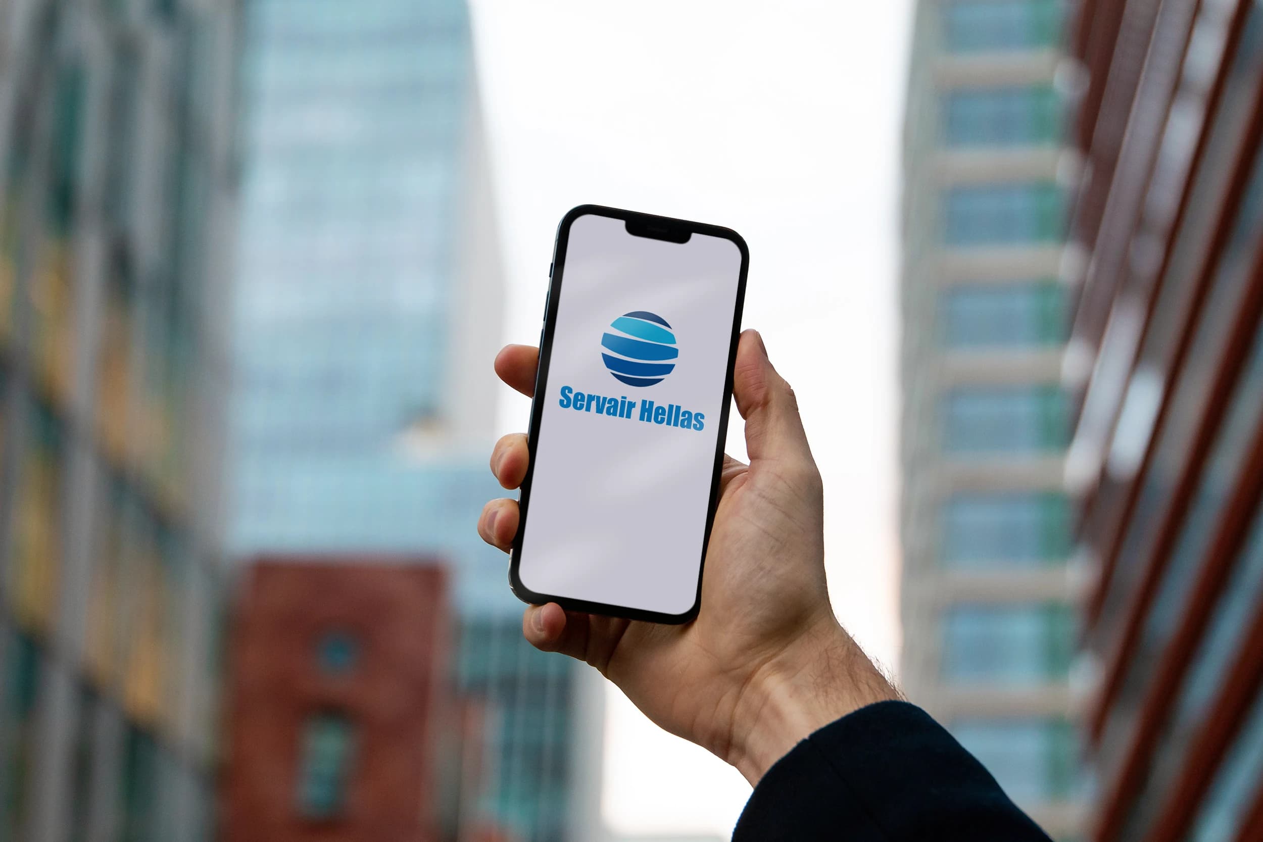 Hand holding mobile phone with Servair app